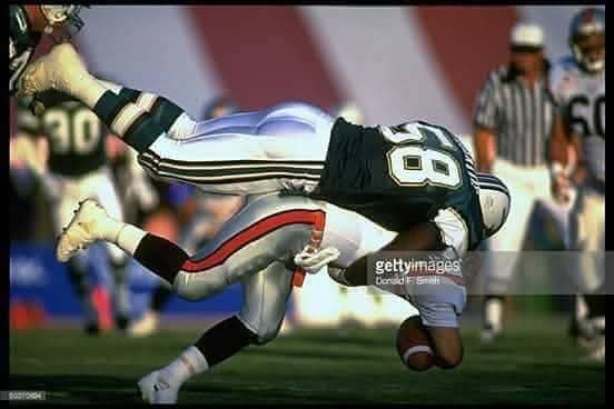 Professional football tackle action photograph
